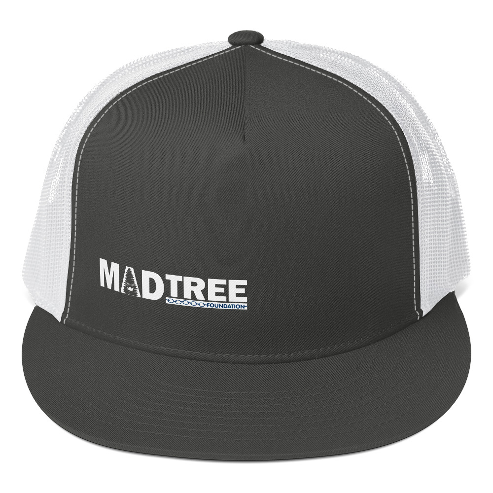 The Trucker Cap is a black and white snapback hat with a mesh back and "MADTREE" in white capital letters on the front, featuring a tree graphic inside the letter A.