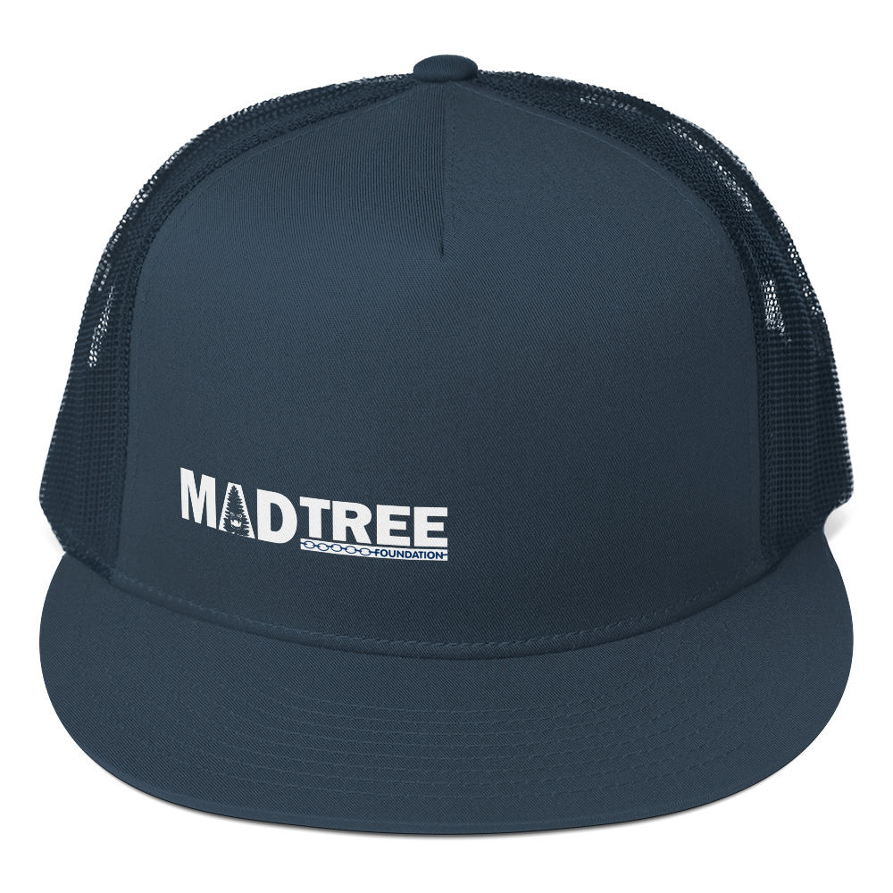 The Trucker Cap is a navy blue snapback hat with a mesh back and "MADTREE FOUNDATION" in white text on the front panel.