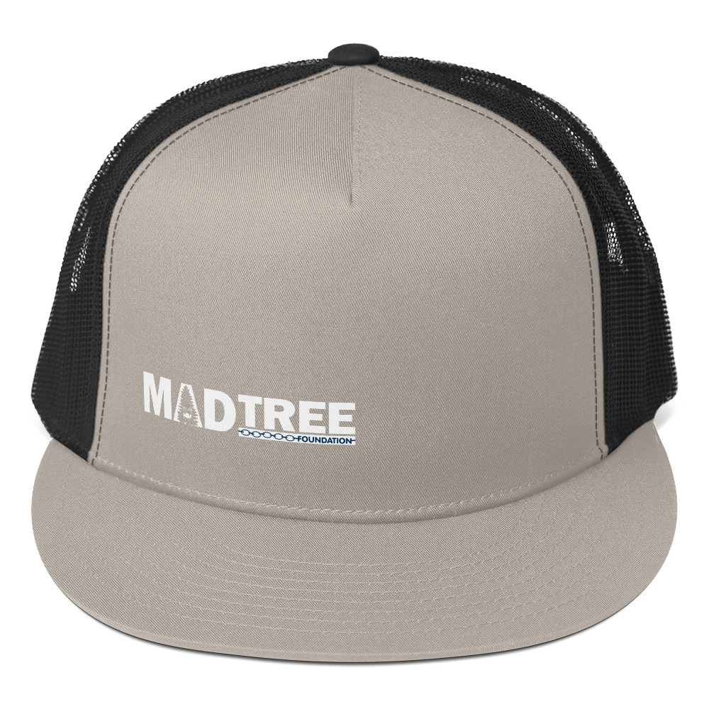 The Trucker Cap features a light gray front with "MADTREE FOUNDATION" in white and a black mesh back.
