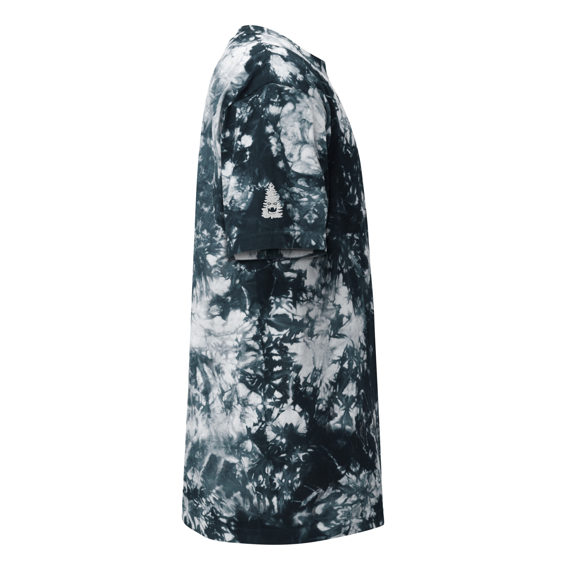 Side view of the Oversized tie-dye t-shirt in black and white with short sleeves, featuring a small white tree graphic on the sleeve. Displayed against a plain white background.