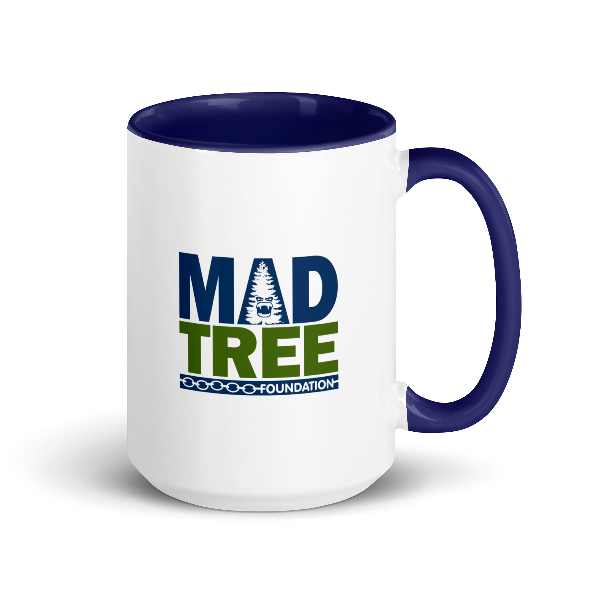 The Mug with Color Inside - Mad Tree is a white mug with a blue handle and interior, featuring the MAD TREE FOUNDATION logo in blue and green with a stylized tree wearing sunglasses above the word TREE.