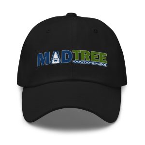 The Hat - Mad Tree is a black baseball cap with MADTREE FOUNDATION embroidered in blue and green, featuring a tree graphic inside the A and a chain design below FOUNDATION.